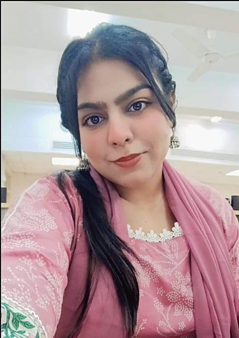 Aleeha in a pink suit, smiling